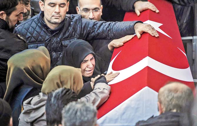 Relatives of security member Fatih Cakmak, 35, mourn during the funeral ceremony in Istanbul. Pic/AFP
