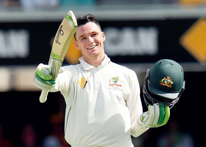 Peter Handscomb celebrates his century during the second day-night cricket Test between Australia and Pakistan in Brisbane on December 16, 2016. Pic/AFP