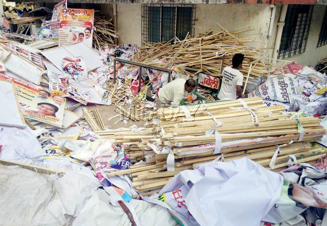 Posters and hoardings of political parties are being pulled down due to the approaching BMC elections, and kept in the ward office at Link Road, Borivli West. Pic/Nimesh Dave