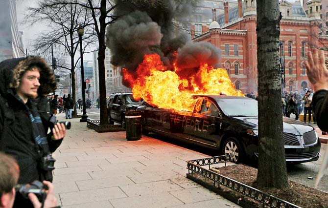 Over 200 protesters were arrested as vandals torched a vehicle and damaged stores after a series of protests marring Donald Trump’s inauguration gave way to violent street clashes. Pic/AFP