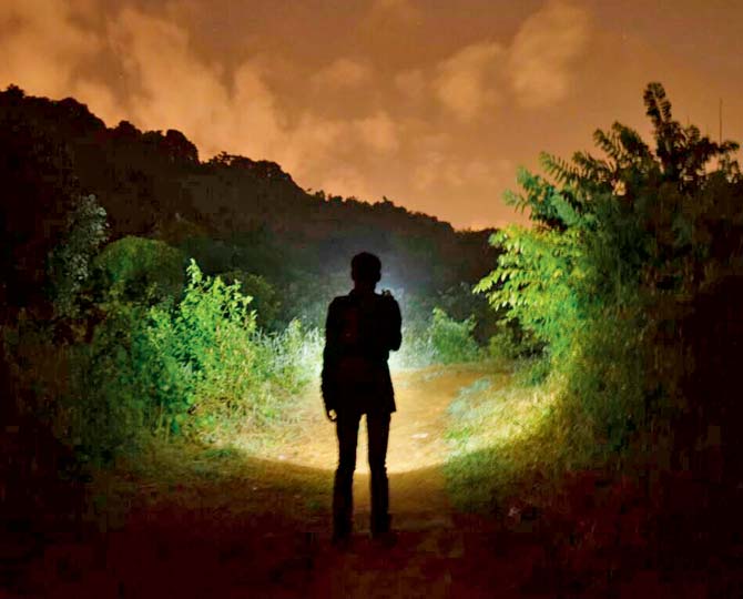Some locals use torches while walking the path at night