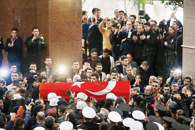 A coffin is carried during the funeral ceremony of Turkish police officer Fethi Sekin and courthouse officer Musa Can, who were killed in Izmir on Thursday. Pic/AFP