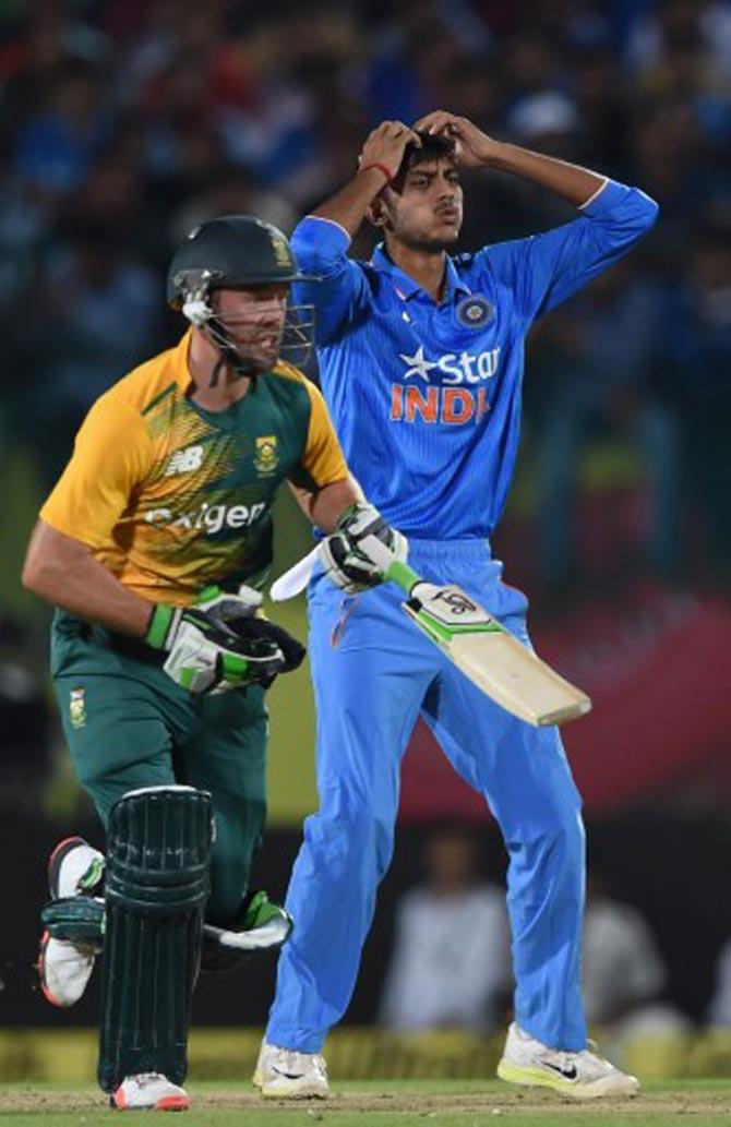 AB de Villiers takes a run as Axar Patel looks on
