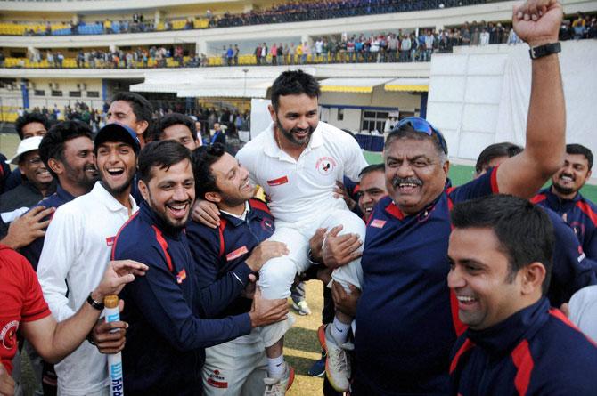 Gujarat players lift skipper Parthiv Patel as they celebrate after beating Mumbai to clinch their maiden Ranji trophy title at Holkar Stadium in Indore on Saturday. Pic/PTI
