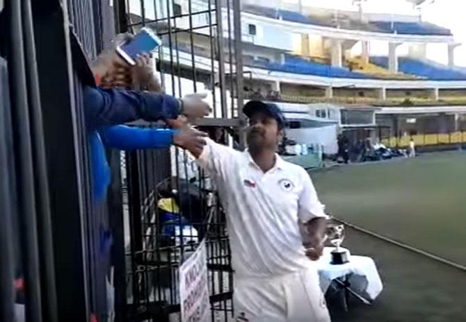 RP Singh snatches the phone from the fan