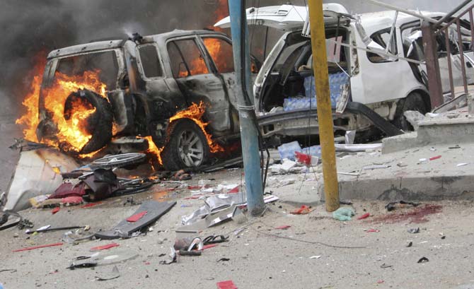 Burning vehicles outside Midnimo mall after a car bomb attack on a popular mall in Mogadishu, Somalia. Pic/AFP