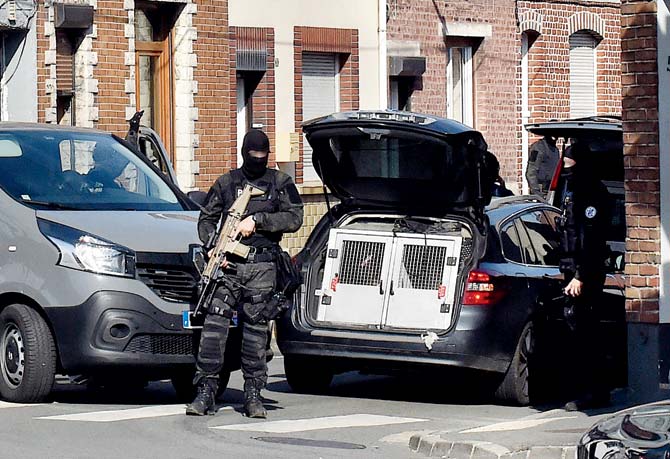 Police officers of an anti-terrorism unit and of French intelligence agency (DGSI) patrol in a street on Wattignies, northern France, during the operation to pick up a man on suspicion of links to the Kamikaze Riders, an ISIS-related group. Pic/AFP