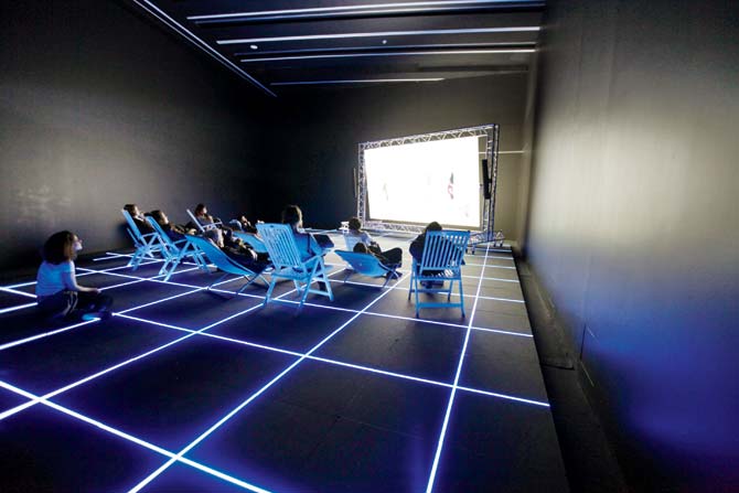 A raster grid of blue light strips transforms the space into a motion capture studio, in which human movement is converted into data 