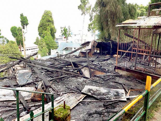 The charred tourist resource Centre in Darjeeling on Thursday, which was set on fire by the protesters. Pic/PTI