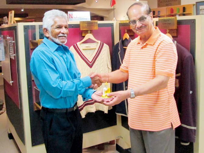 Ravi Chaturvedi presents former West Indies wicketkeeper Deryck Murray with a statue of Lord Buddha for the museum of Queen’s Park Cricket Club, Trinidad