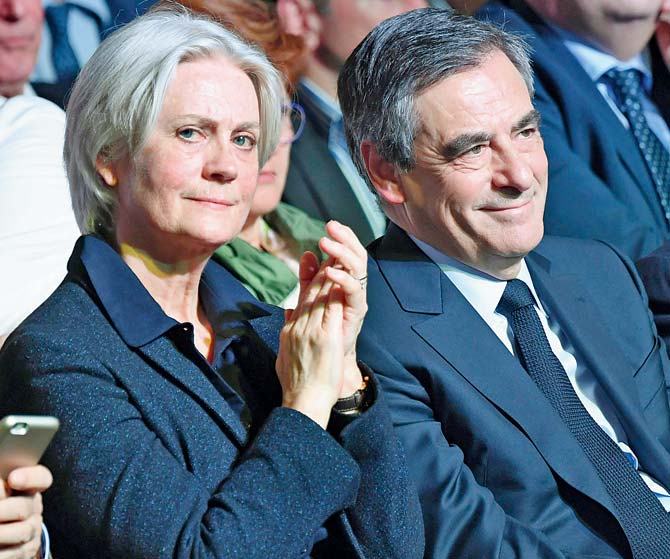 The rules were adopted in response to a scandal involving former Prime Minister Francois Fillon (right) and his wife, Penelope. Pic/AFP