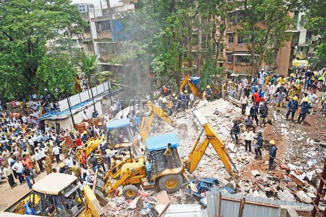 Firemen and a team from NDRF carry out rescue operations at the site of the Ghatkopar building collapse