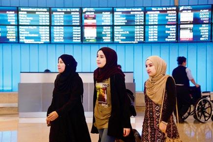 Toned down travel ban rolls out calmly in US