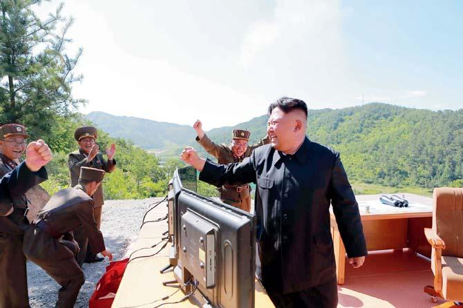 North Korean leader Kim Jong-Un reacts after the test. Pics/AFP