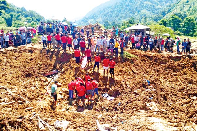 National Disaster Response Force personnel in a rescue operation at the site of the landslide in Laptap village. Pic/AFP