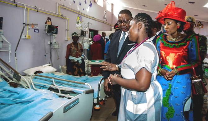 An official of the Kamuzu Central Hospital briefs Malawi President Peter Mutharika (C) and First Lady Gertrude Mutharika (1st-R) as they visit several injured people due to a stampede at the newly open Bingu Wa Mutharika Stadium in the Capital Lilongwe during the celebrations of the republic