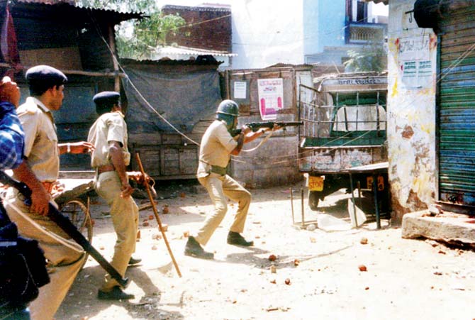 A file picture from the Millat Nagar district in Ahmedabad during the 2002 riots. RSS scholar Dina Nath Batra wants a reference to nearly 2,000 Muslims being killed in the riots in Gujarat to be removed from textbooks. File pic/AFP