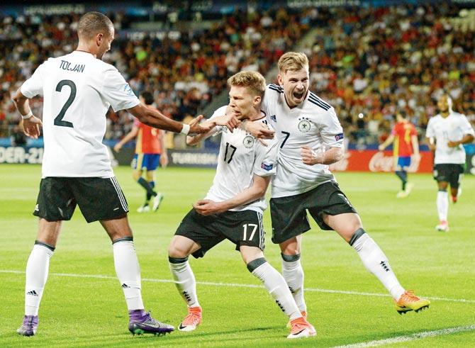Germanys Mitchell Weiser (centre) celebrates his goal against Spain with teammates during the final in Krakow. PIC/Getty Images