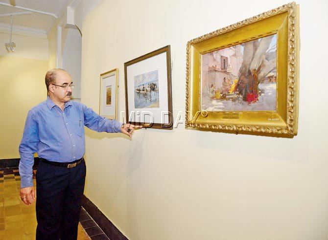 Sabyasachi Mukherjee points out to a detail of a watercolour exhibit