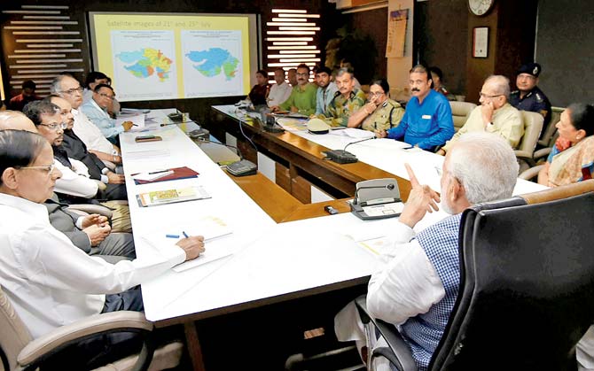 PM Narendra Modi in a meeting on the floods in Gujarat. Pic/AFP