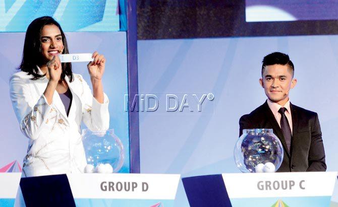 India badminton star PV Sindhu (left) draws a group position as national football skipper Sunil Chettri looks on during the official draw of the FIFA Under-17 World Cup in Mumbai yesterday. Pic/Suresh Karkera