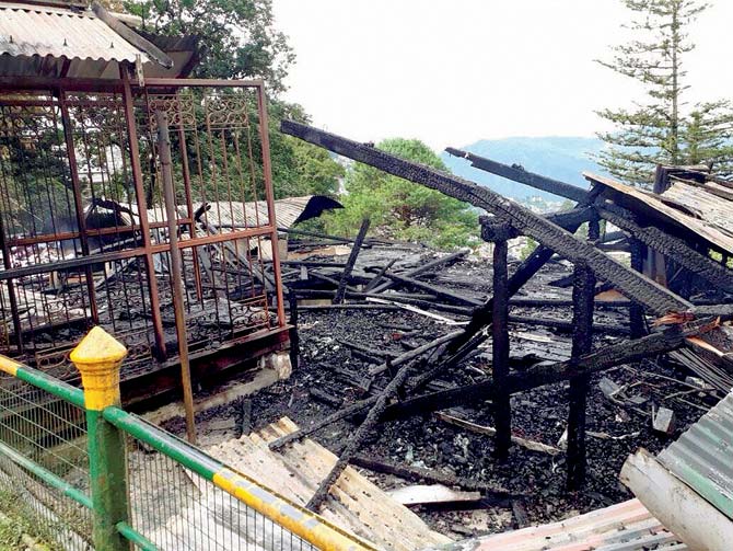 The charred Tourist Resource Centre in Darjeeling that was set ablaze by protesters on Thursday. Pic/PTI