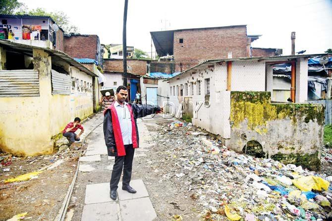 Pawan Pal points to the public toilet in Jay Bhim Nagar, Powai which is filthy and in need of repairs. Pics/Sameer Markande