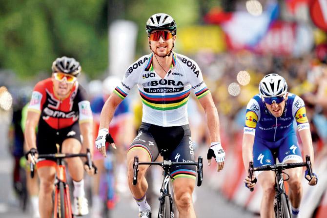 Peter Sagan (centre) crosses the finish line to win Stage Three of  Tour de France between Verviers and Longwy yesterday. Pic/AFP
