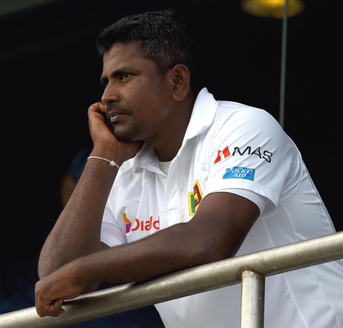 Sri Lankan cricket captain Rangana Herath looks on from the team