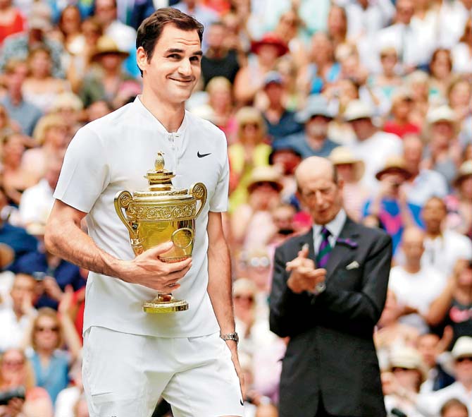 Roger Federer holds the winner