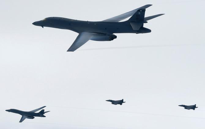 This handout photo taken on July 8, 2017 and provided by the South Korean Defence Ministry in Seoul shows the B-1B Lancers (top and L) flying over South Korea during a South Korea-US joint live fire drill conducted at a range in Yeongwol County. US bombers carried out a rare live fire drill in South Korea on July 8, flying close to the DMZ in a show of force after Pyongyang