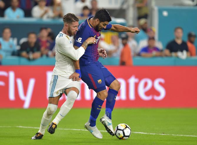 Luis Suarez (R) of Barcelona vies for the ball with Sergio Ramos (L) of Real Madrid during their International Champions Cup football match at Hard Rock Stadium on July 29, 2017 in Miami, Florida. Pic/AFP