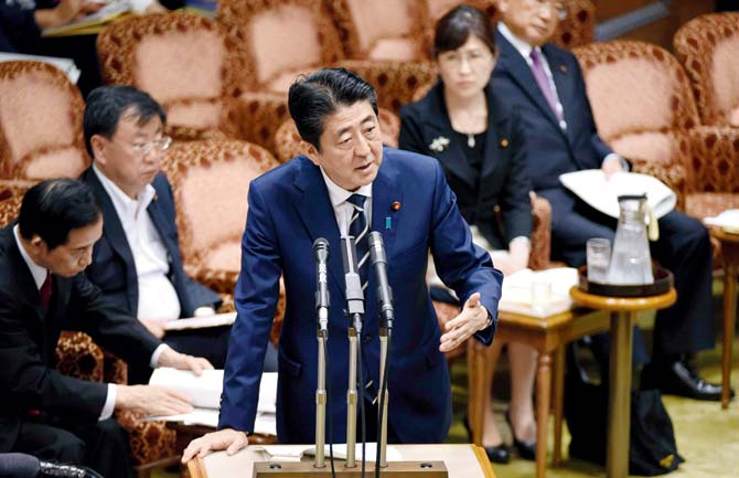 Shinzo Abe answers questions in the Upper House at parliament in Tokyo on Tuesday. Pic/AFP