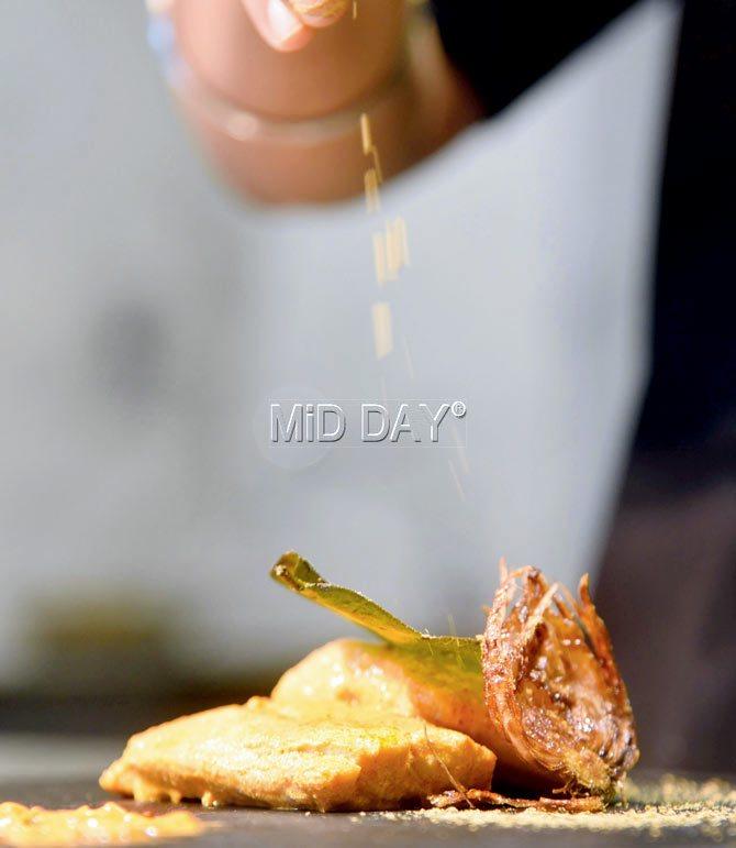 The Naga spring salt being sprinkled on the fish mejenga leaf. Pics/Nimesh Dave