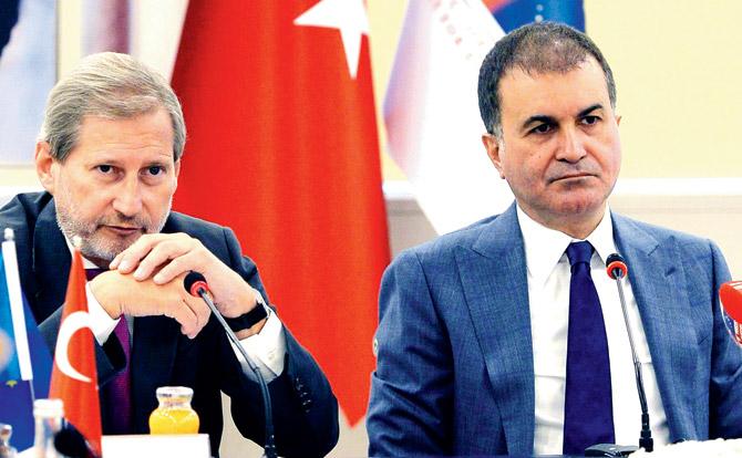 European Commissioner for Enlargement Johannes Hahn (L) and Turkish EU Affairs Minister Omer Celik on Thursday. PIC/AFP