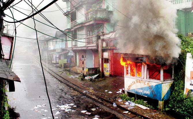A traffic police post on fire after it was torched by the Gorkha Janmukti Morcha supporters during their violent protest in Darjeeling. Pic/PTI