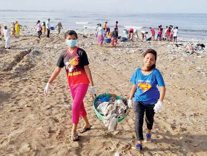 Children pick up the trash at the Versova beach