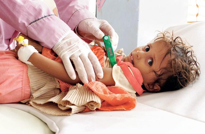 A Yemeni child is checked by a doctor at a hospital. Pic/AFP