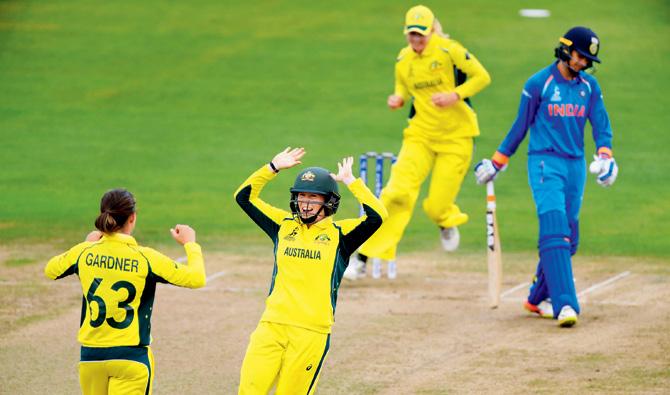 Australian players celebrate the dismissal of India