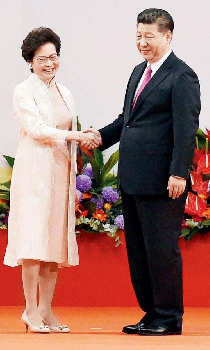 Hong Kong’s new Chief Executive Carrie Lam (left) with China’s President Xi Jinping after being sworn in as the territory’s new leader. Pics/AFP