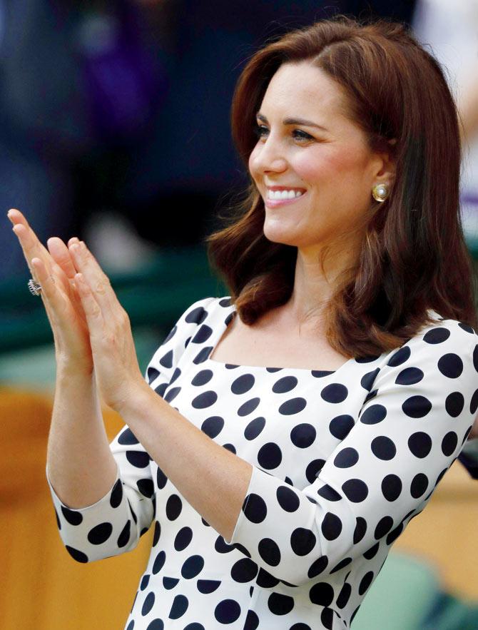 Catherine, Duchess of Cambridge applauds as she soaks in the opening day
