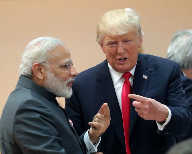 US President Donald Trump (R) talks with India