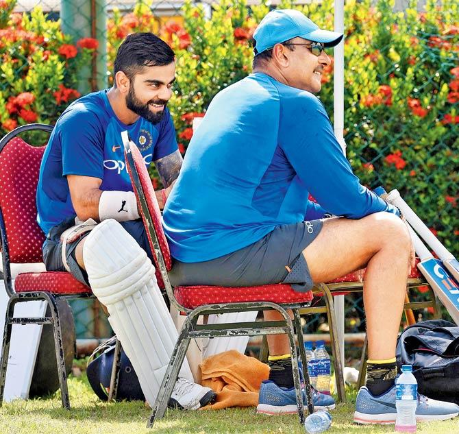 Team India captain Virat Kohli (left) and newly-appointed head coach Ravi Shastri have something to laugh about during the team’s nets session at the Galle International Cricket Stadium yesterday. Pic/AFP