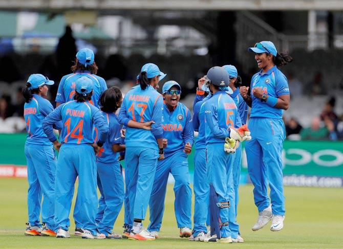 Indian eam members celebrate after taking a wicket of England during the ICC Women