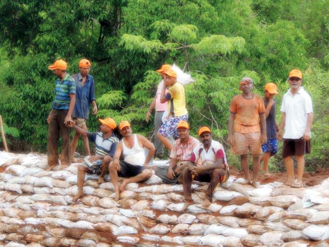 Villagers get together to work along the river