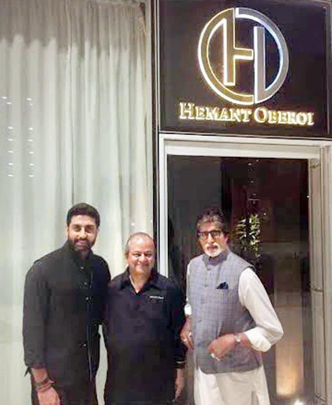 Abhishek and Amitabh Bachchan with (centre) Hemant Oberoi