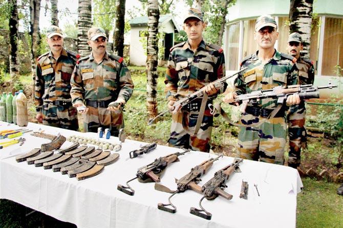 The Army displays arms and ammunition recovered from infiltrators killed during an anti-militancy operation in Uri Sector yesterday. Pic/PTI