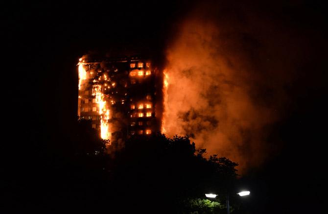 This handout image received by local resident Giulio Thuburn early on June 14, 2017 shows flames engulfing a 27-storey block of flats in west London. Pic/AFP