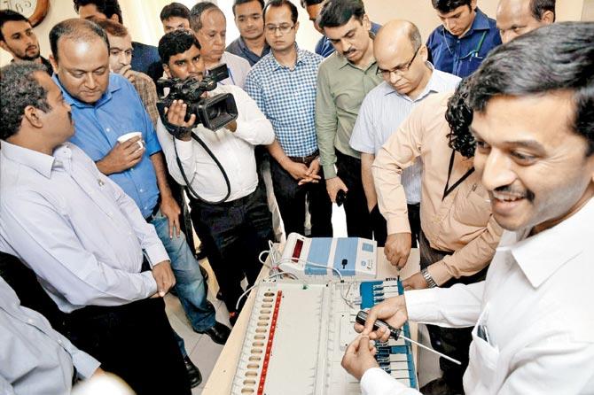 CPI(M) members watching a demo on the EVM. Pic/PTI