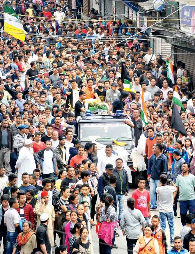 Supporters of the separatist Gorkha Janmukti Morcha take part in a rally with a slain protester